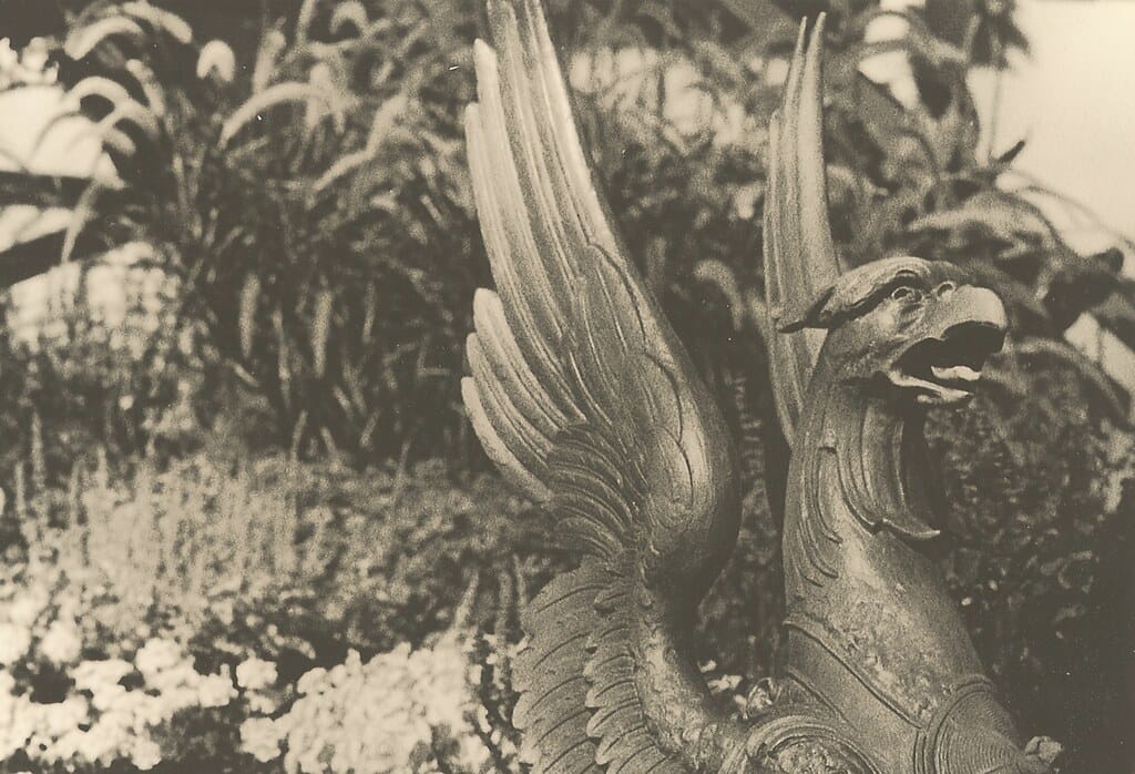 Black and white photo of a bronze gryphon statue.