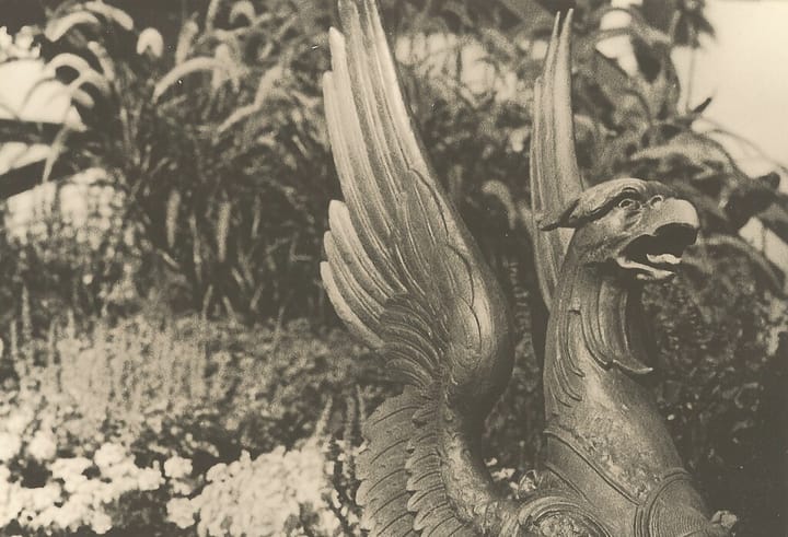 Black and white photo of a bronze gryphon statue.